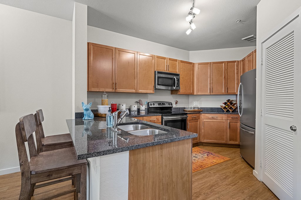 a kitchen with a granite counter top and a sink