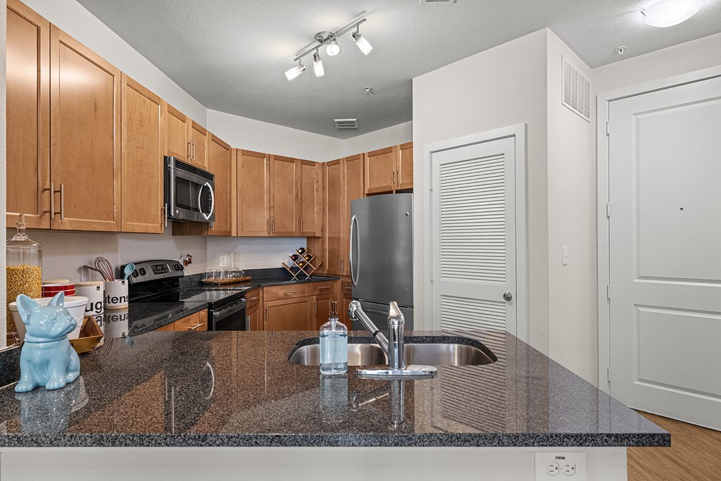 a kitchen with granite counter tops and a sink