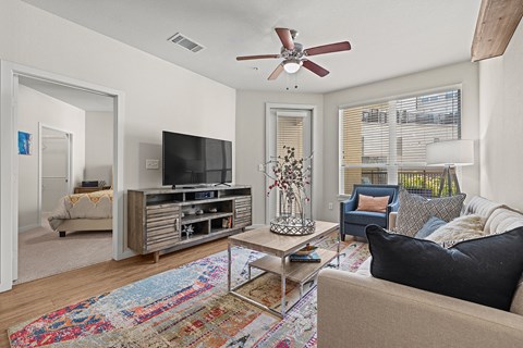 a living room with a couch and a ceiling fan