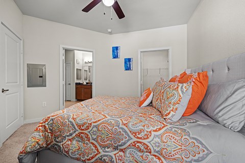 a bedroom with a large bed and a ceiling fan