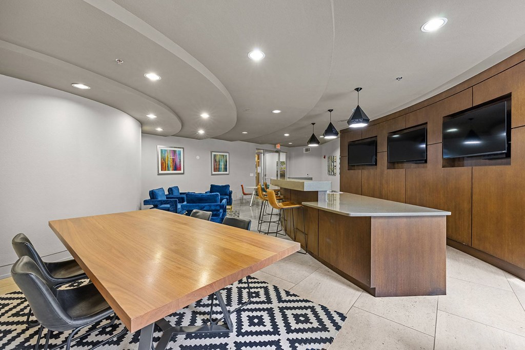 a dining room and kitchen with a table and chairs