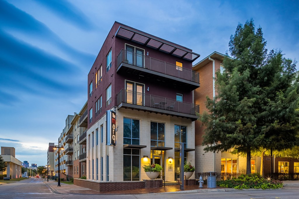 a building with a purple and white facade on a city street
