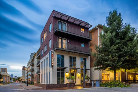 a building with a purple and white facade on a city street