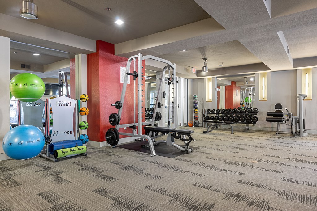 a gym with weights and other exercise equipment in a building