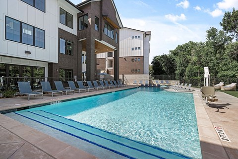 a swimming pool with a building in the background