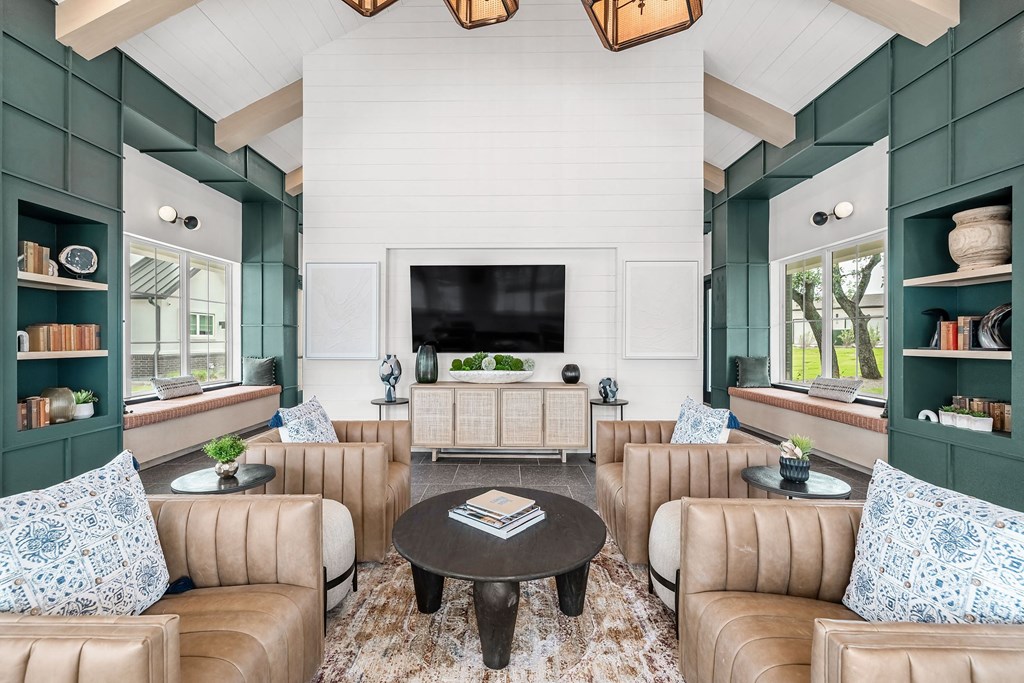 a living room with couches and a table and a television