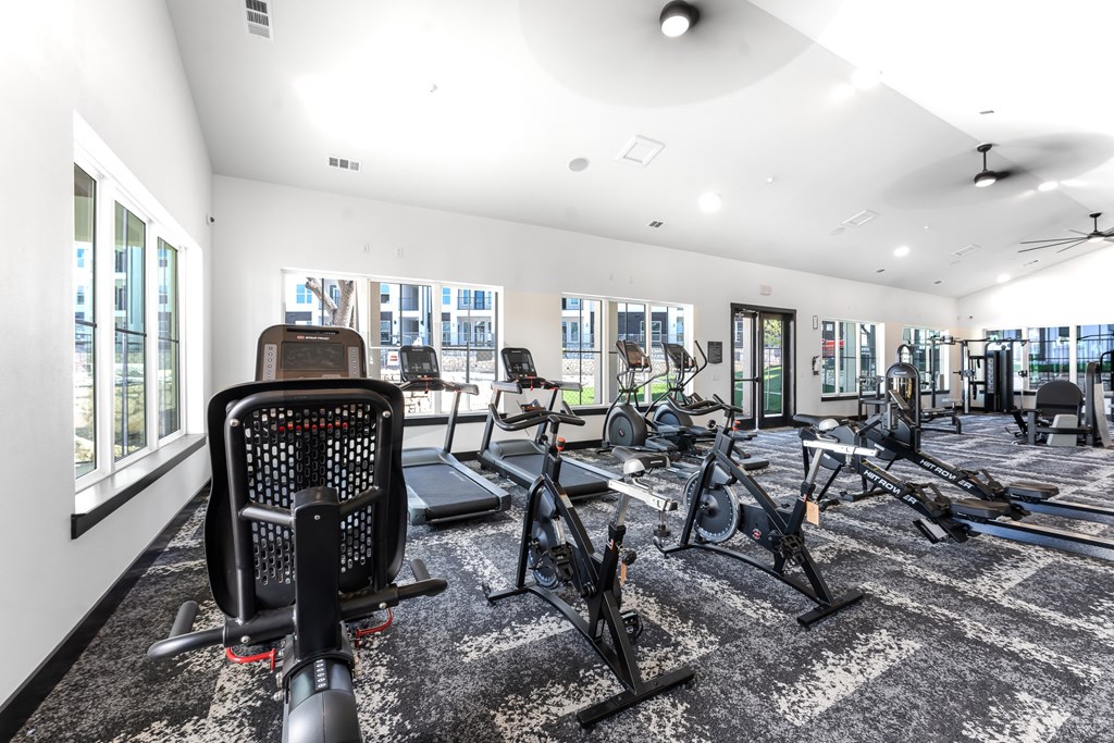 the gym with treadmills and other exercise equipment at the belgard apartments