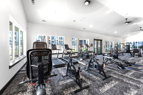 the gym with treadmills and other exercise equipment at the belgard apartments