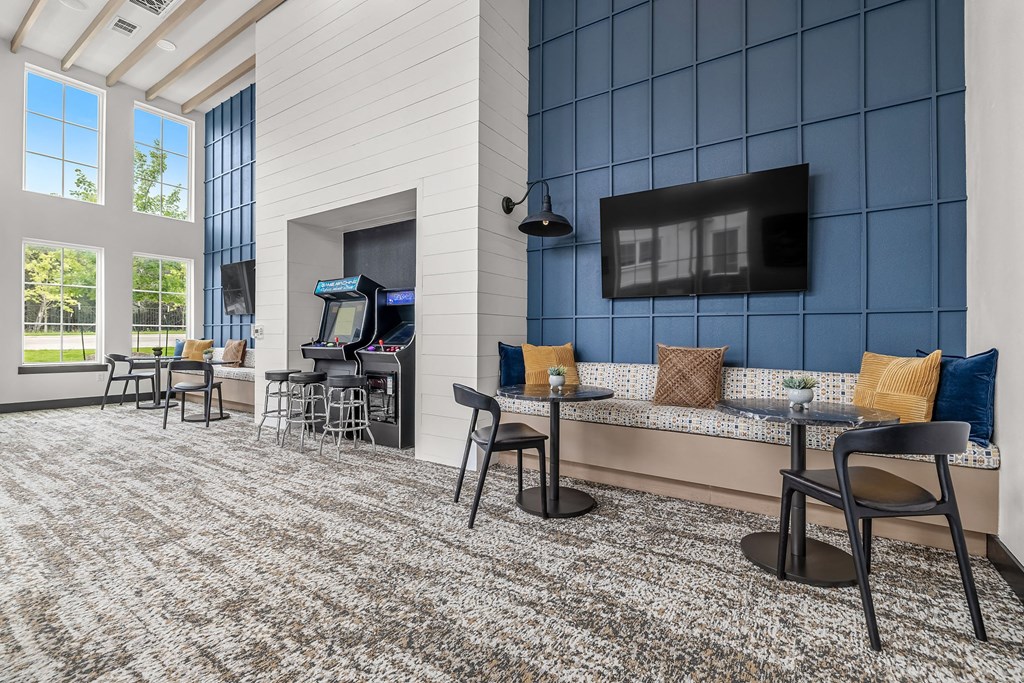 a living room with tables and chairs and a television
