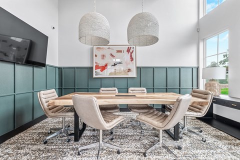 a dining room with a table and chairs and a tv
