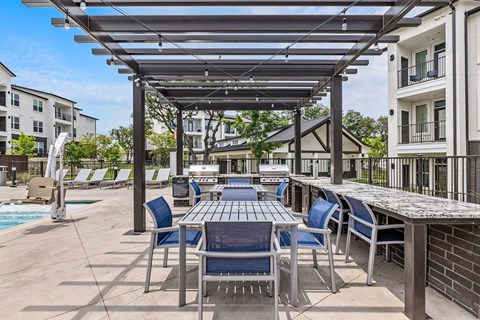 a patio with a table and chairs under awning