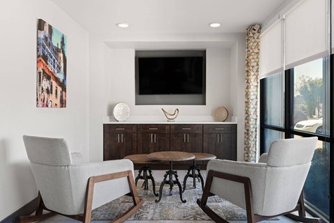 A living room with a grey chair and a brown table.