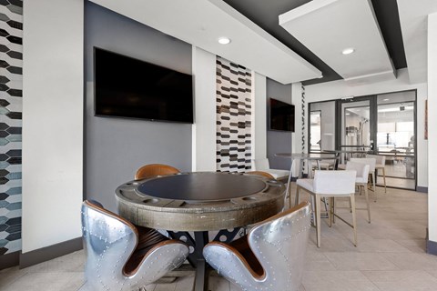 A modern dining room with a round table and chairs.
