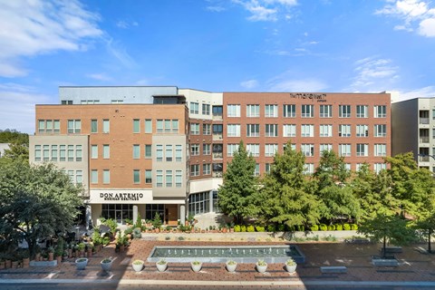 A large building with a fountain in front of it.