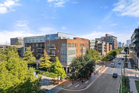 A city street with cars and buildings.