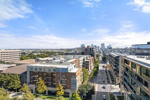 A cityscape with buildings and a road in the foreground.