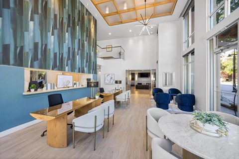 A modern office with blue and white walls and wooden furniture.