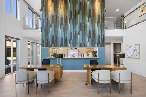 A modern dining room with a long table and chairs.