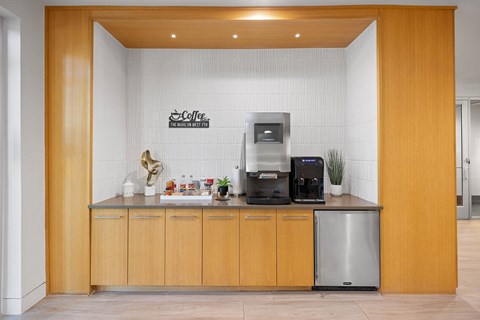A coffee bar with a wooden counter and a coffee machine.