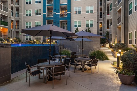 A patio with a table and chairs is set up outside a building.