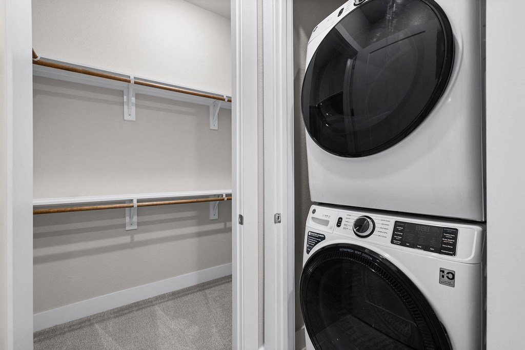 a washer and dryer in a laundry room with a white wall