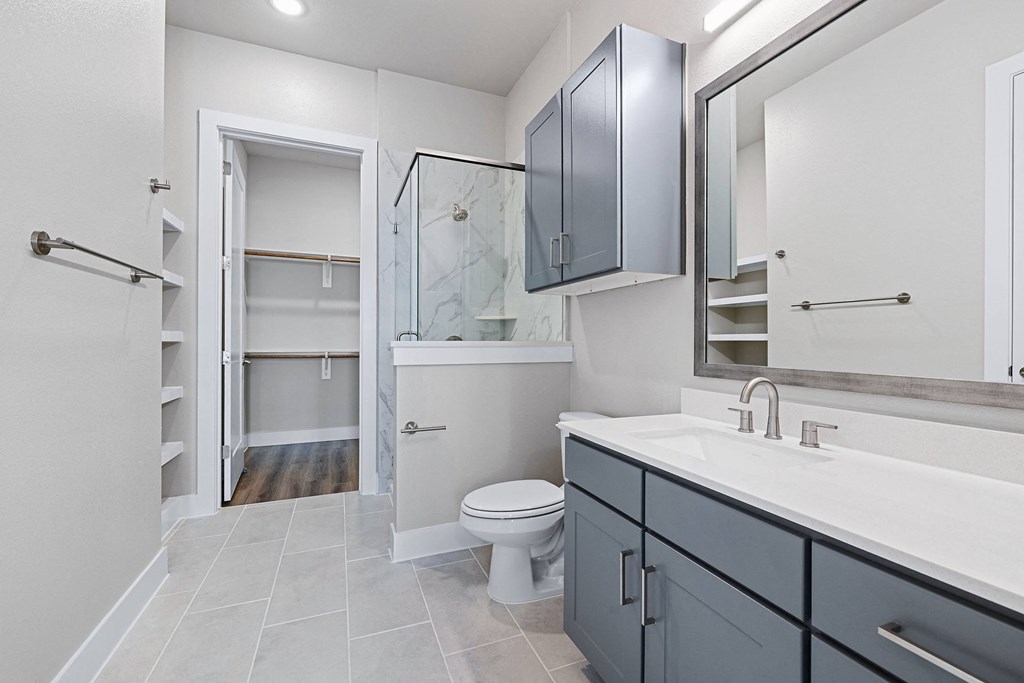 a bathroom with a shower and a sink and a toilet
