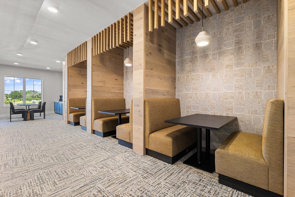 a seating area with chairs and tables in a lobby
