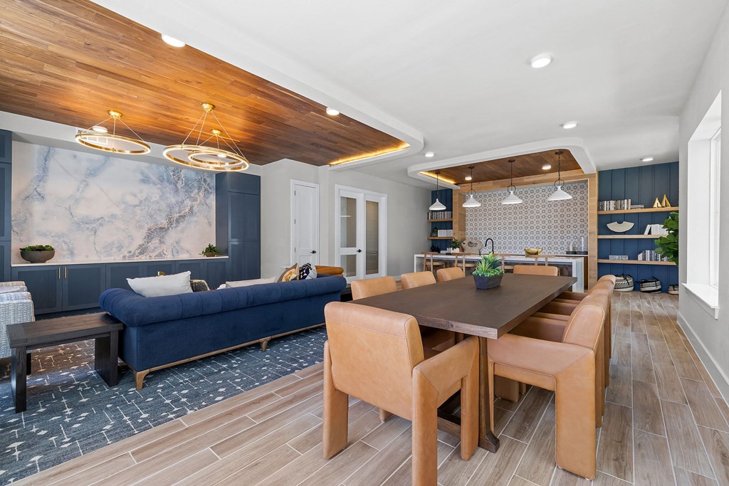 a dining room with a wooden table and chairs and a blue couch