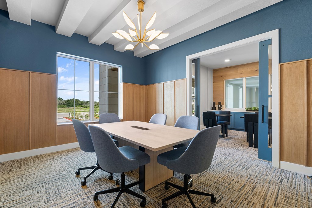a conference room with a table and chairs