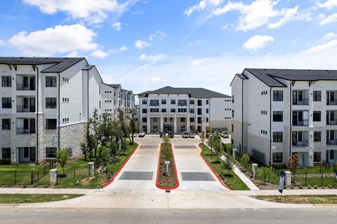a row of apartment buildings on the side of a street