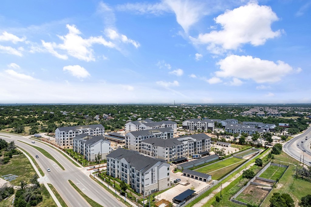 an aerial view of an urban area with buildings and a highway