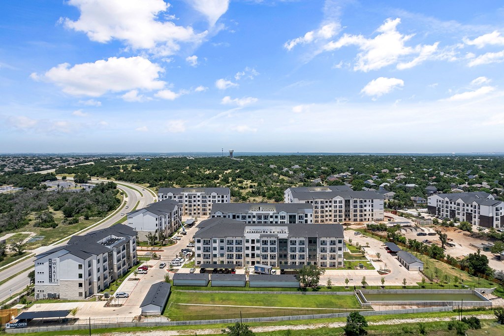 an aerial view of a city with tall buildings and a highway