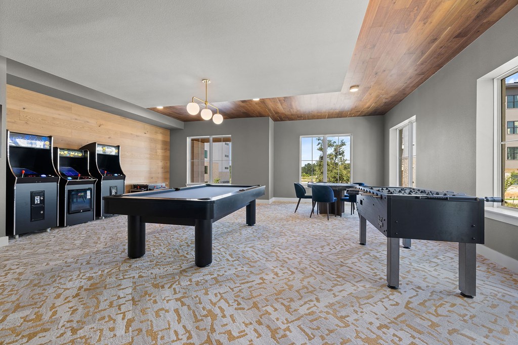 two pool tables in a game room with a lot of machines