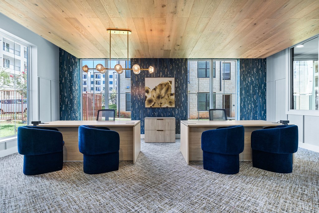 a conference room with blue chairs and wooden ceilings and a window