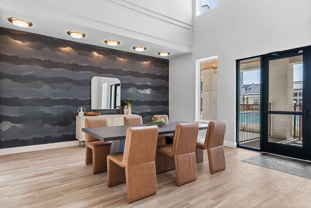 a dining room with a table and chairs