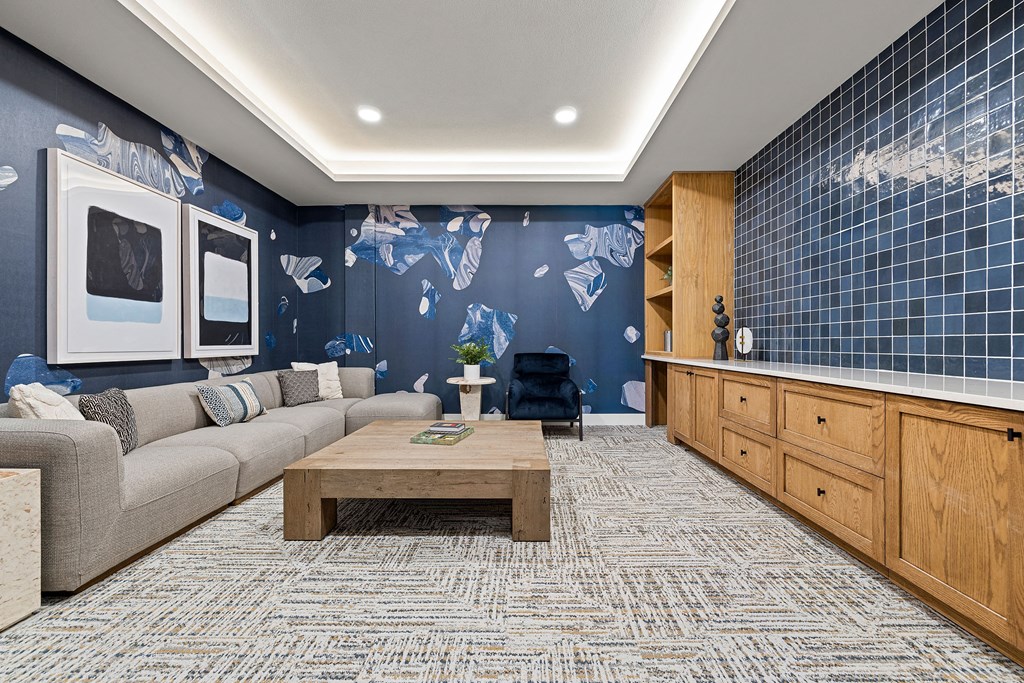 a living room with blue walls and a couch and a coffee table