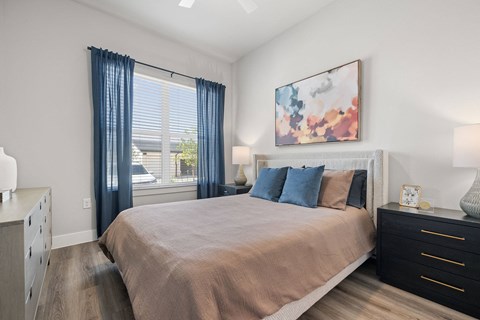 a bedroom with a large bed and a window