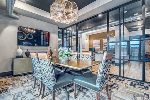 A modern dining room with a wooden table and chairs.