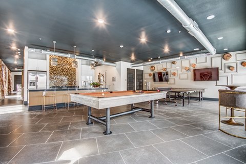 A large room with a long table and chairs.