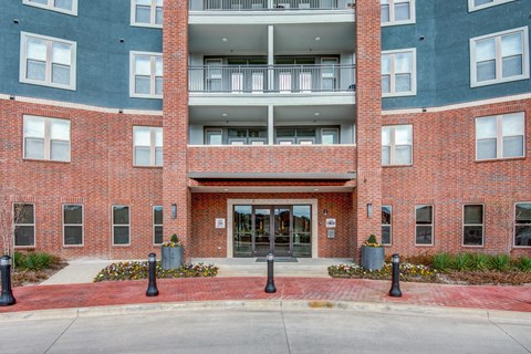 A red brick building with a glass door and windows.
