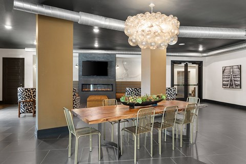 A modern dining room with a wooden table and chairs.
