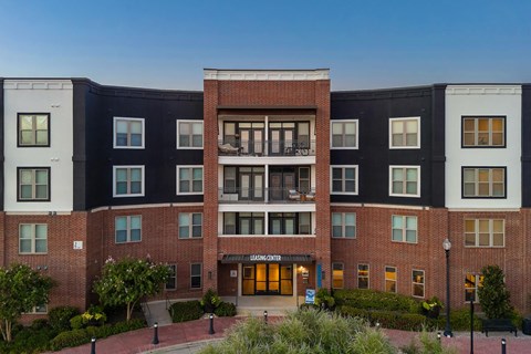 A multi-story building with a brick facade and a sign that reads