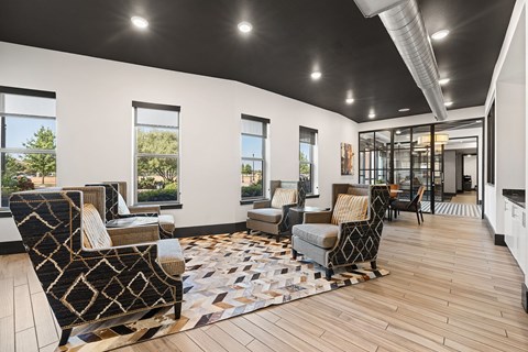 A living room with a patterned rug and a black and white chair.