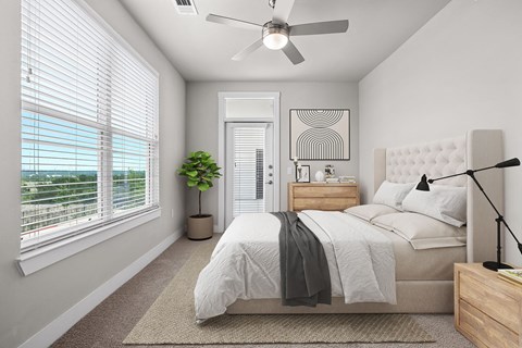 an open bedroom with a bed and a ceiling fan