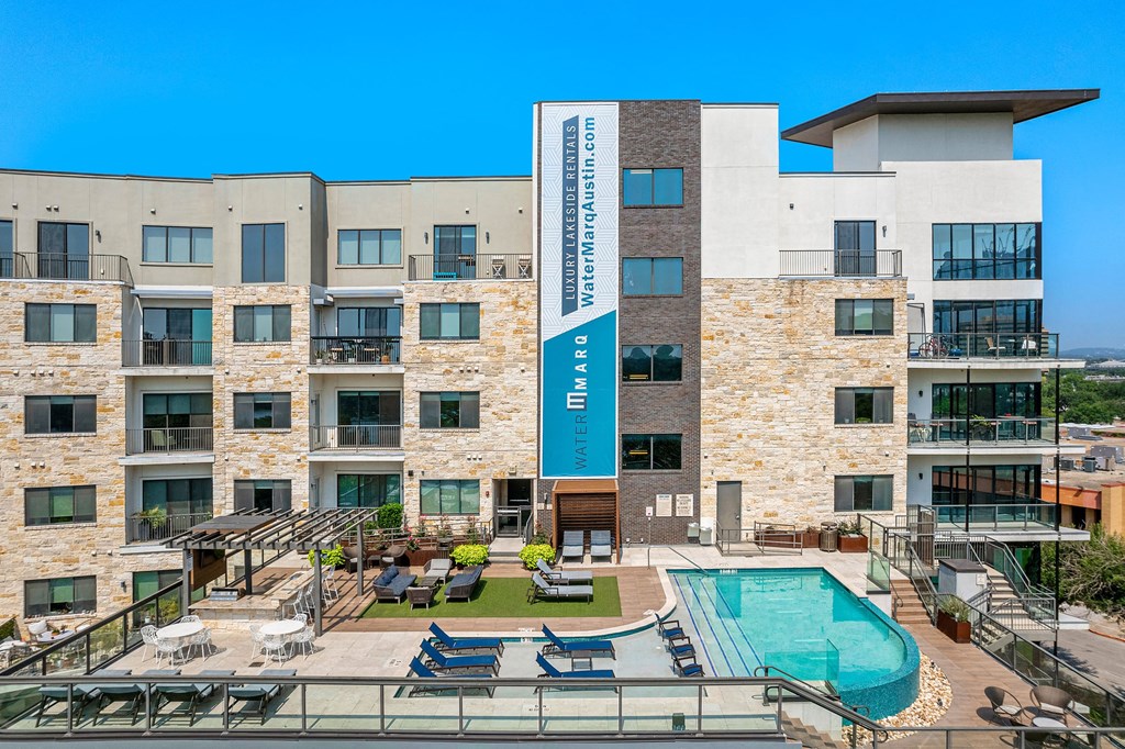 a building with a swimming pool and a hotel sign