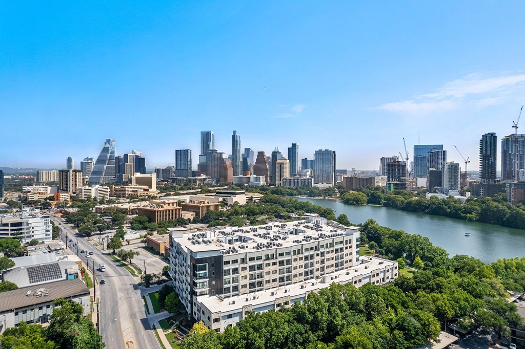 an aerial view of a city with a river and skyscrapers