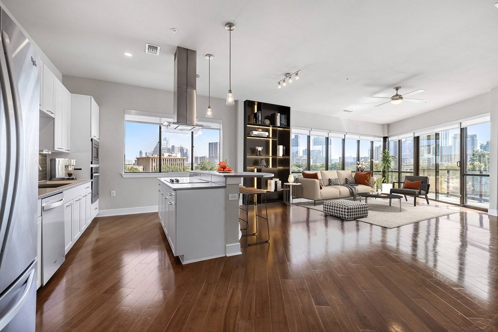 an open living room with a kitchen and a city view