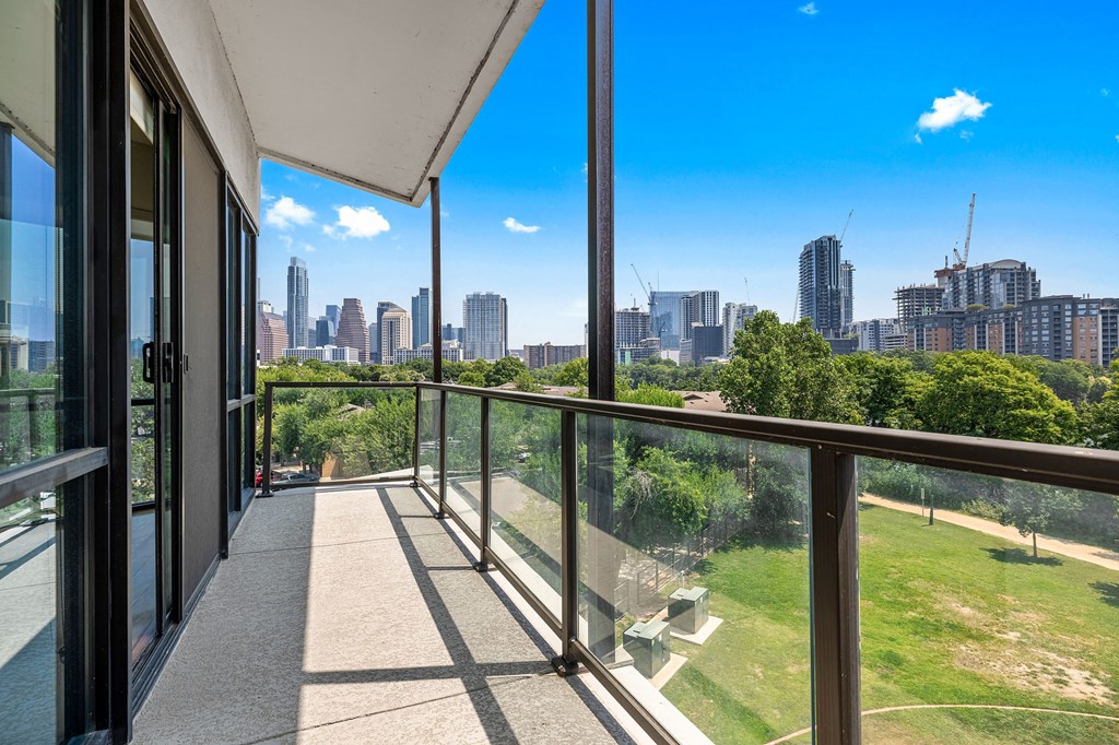 the view of the city from the balcony of a condo