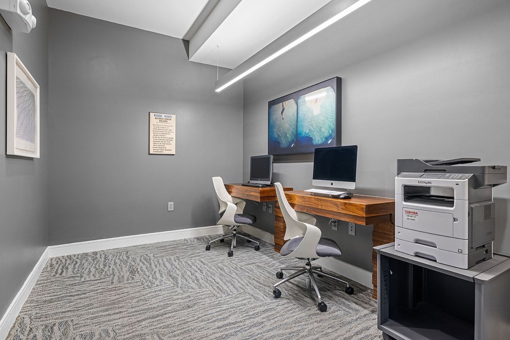 a home office with a computer and a printer on a desk