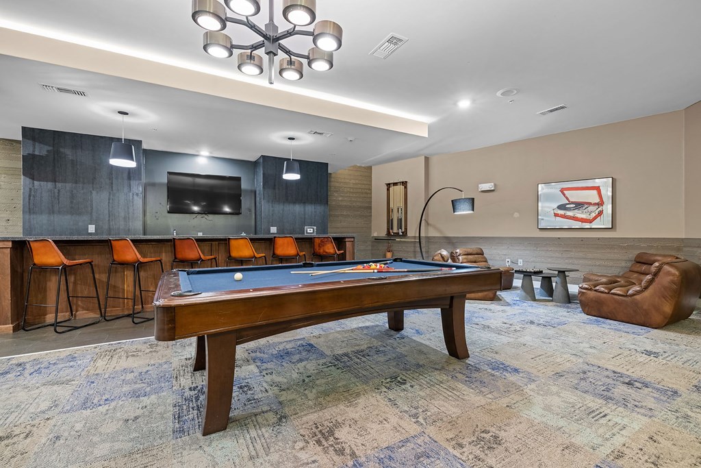 a game room with a pool table and a tv